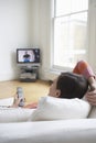 Woman On Couch Watching TV Royalty Free Stock Photo