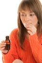 Woman with cough syrup Royalty Free Stock Photo