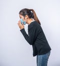 A woman coughing and covering her mouth with her hand Royalty Free Stock Photo