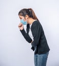 A woman coughing and covering her mouth with her hand Royalty Free Stock Photo