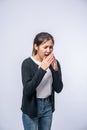 A woman coughing and covering her mouth with her hand Royalty Free Stock Photo