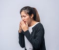 A woman coughing and covering her mouth with her hand Royalty Free Stock Photo