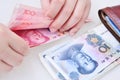Woman counting Chinese yuan banknotes