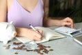 Woman counting coins at grey marble table. Money savings Royalty Free Stock Photo