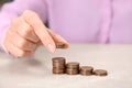 Woman counting coins at light table Royalty Free Stock Photo