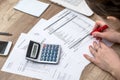 Woman counting her budget, hands with calculator