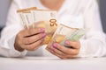 Woman Counting Money. Close up of female hands counting 50 and 100 euro banknotes. Euro currency exchange. Cash money Royalty Free Stock Photo