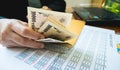 Woman is counting money with statement paper financial concept. Royalty Free Stock Photo