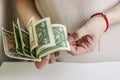 Woman counts US dollars, female hands close-up. Person with money, concept of a salary, shopping Royalty Free Stock Photo
