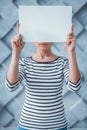 Woman covering eyes with white piece of paper Royalty Free Stock Photo