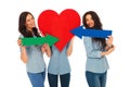 Woman covering face with a big heart , friends pointing arrows Royalty Free Stock Photo