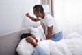 Irritated African Couple Disturbed By Noise On Bed