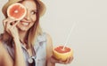 Woman covering her eye with grapefruit. Fun summer Royalty Free Stock Photo