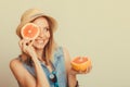 Woman covering her eye with grapefruit. Fun summer Royalty Free Stock Photo