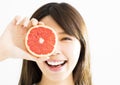 Woman covering her eye with grapefruit Royalty Free Stock Photo