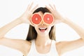 Woman covering her eye with grapefruit Royalty Free Stock Photo