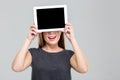 Woman covering her eyes with blank tablet computer screen Royalty Free Stock Photo