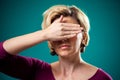 Woman covering her eyes with hand. People, lifestyle and emotions concept Royalty Free Stock Photo