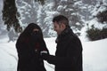 Woman covering her eyes while man giving surprise gift in forest Royalty Free Stock Photo