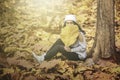 Woman covering her face with dried autumn leaves Royalty Free Stock Photo