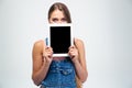 Woman covering her face with tablet computer Royalty Free Stock Photo