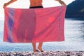 Woman on beach covering hips with towel Royalty Free Stock Photo