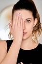 Woman covering one eye with her manicured hand Royalty Free Stock Photo