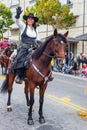 Woman - cowboy in a hat rides horse