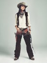 Woman, cowgirl and outfit in studio, portrait and costume for western casting with rope or whip. Female person, cowboy Royalty Free Stock Photo