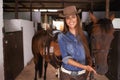 Woman or cowgirl, portrait and horse in barn to train or feed and grooming for animal or pet care. Person, stallion and Royalty Free Stock Photo