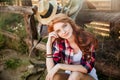Woman cowgirl sitting and relaxing outdoors Royalty Free Stock Photo