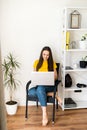 Woman in a cozy home atmosphere with a laptop Royalty Free Stock Photo