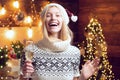 Woman cozy knitted sweater enjoy christmas atmosphere at home. Girl winter clothes santa claus hat celebrate christmas