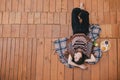 Woman on cozy terrace of wooden house, top view