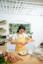 Woman cracking eggs into glass bowl