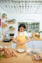 Woman cracking eggs into glass bowl