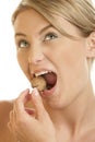 Woman cracking walnut with her teeth Royalty Free Stock Photo