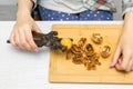 woman cracking walnuts with a hand-held nutcracker Royalty Free Stock Photo