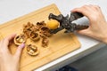 woman cracking walnuts with a hand-held nutcracker. Royalty Free Stock Photo