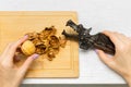 woman cracking walnuts with a hand-held nutcracker. Royalty Free Stock Photo