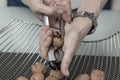 Woman cracking walnuts with nutcracker on metal basket Royalty Free Stock Photo