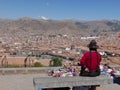 Woman crafts items seller and aerial view of Cusco city