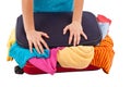 Woman crammed full of clothes in red suitcase Royalty Free Stock Photo