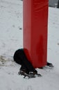 The woman crashed at high speed into a foam barrier on a pole near the ski slope. She is injured, but saved by a red protective ma Royalty Free Stock Photo