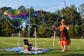 Woman Creates Huge Coloful Bubbles At Georgia Festival