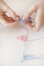 Woman creating a home made piece of cloth for a baby girl