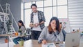 Woman creative designe yawn and fall sleepy when  colleague buy coffee cup to her.colleague at modern office in morning at desk. Royalty Free Stock Photo