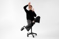 Woman in Creative Pose on Office Chair Royalty Free Stock Photo