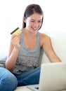 Woman, credit card and laptop on sofa for online shopping sale, e commerce discount or cashback bonus at home. Excited