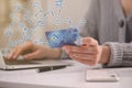 Woman with card using laptop for online payment at table, closeup Royalty Free Stock Photo